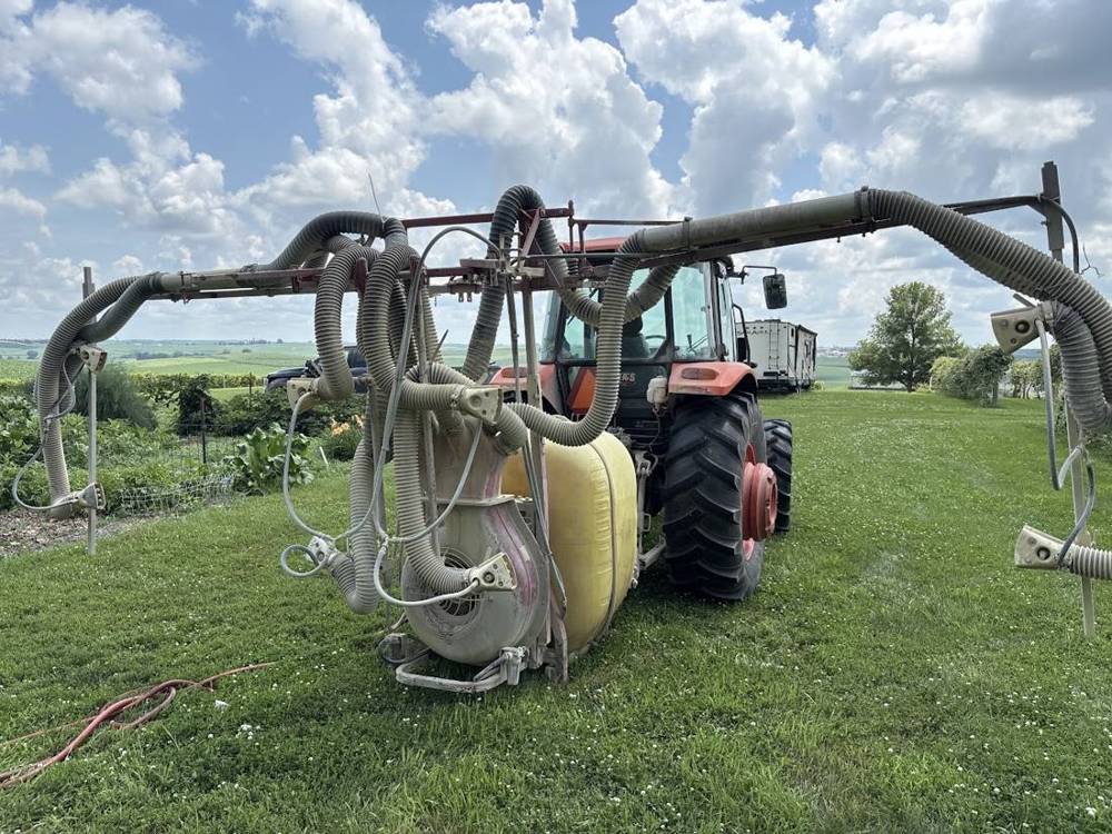 Tractor with airblast sprayer mounted behind