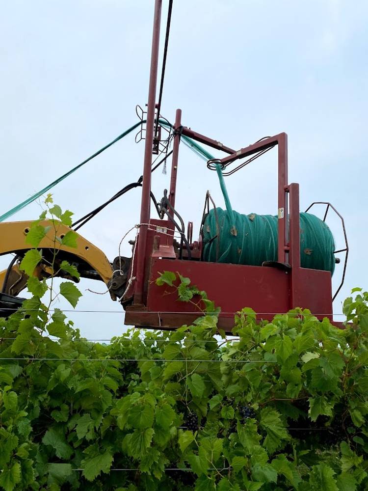 Netter-getter rig laying bird netting over vineyard canopy